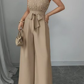 Resim Kadınlar İçin Bej Renkli Kolsuz Yüksek Yaka Geniş Paça Tulum - Hafif Nefes Alabilen Yazlık Kıyafet, Yapılı A Kesim Silüeti ile Günlük ve Resmi Etkinlikler için Makinede Yıkanabilir Düz Renk Tulum 