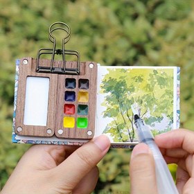 Resim 5 adet Mini Taşınabilir Sanat Seti - 5 adet Mini Ahşap Su Temelli Boya Seti Fırça, Boya, Klips ve Çizim Kitabı ile - 8 Renkli Taşınabilir Açık Hava Sanat Seti - Dekoratif Ev Sanat Malzemeleri 