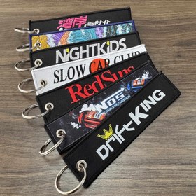 Resim 1 adet JDM Slogan Anahtarlık, Çift Taraflı Nakış, Naylon, Kaplamasız Değerli Metal, Örgüsüz, Kumaş Malzeme, Araba, Motosiklet için, Evrensel Uygulanabilir 